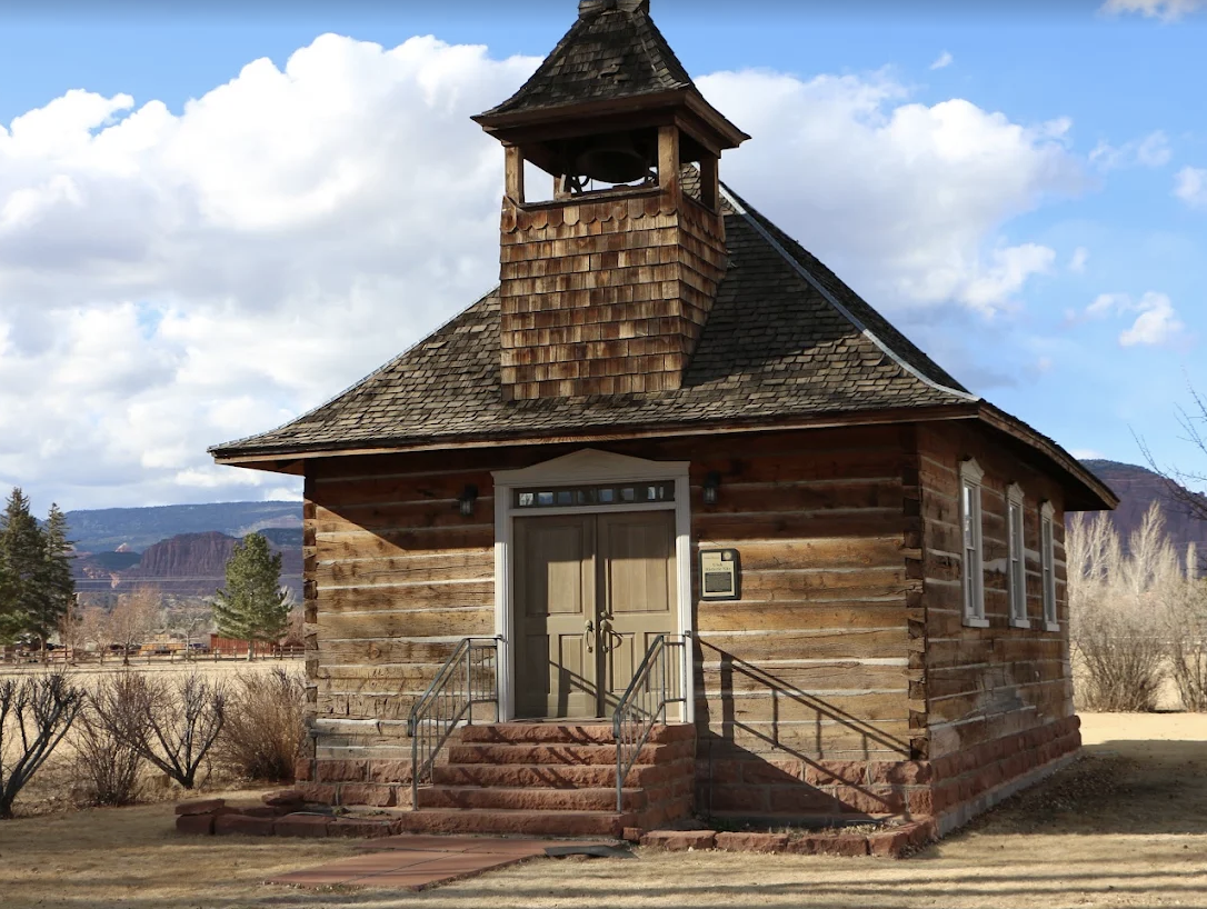 Close view of the bell tower and entrance of the 1898 Torrey Log Church and Schoolhouse in Torrey, Utah